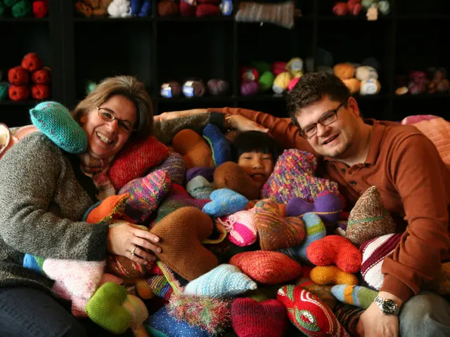 Recycled Cable-Knit Sweater Pillows Adorned with Cheery Pom Poms