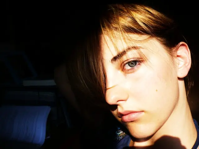 In this image I can see the person wearing the navy blue color dress. To the left I can see some...