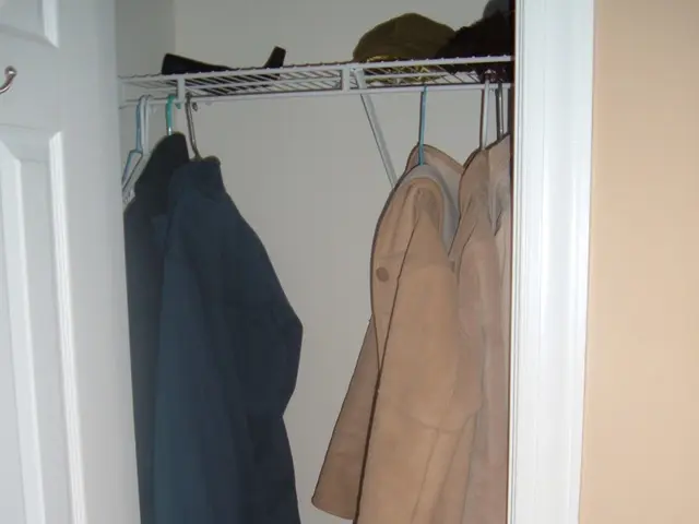 In the image we can see there are shoes and sandals kept on the shoe stand. There is a bag kept on...