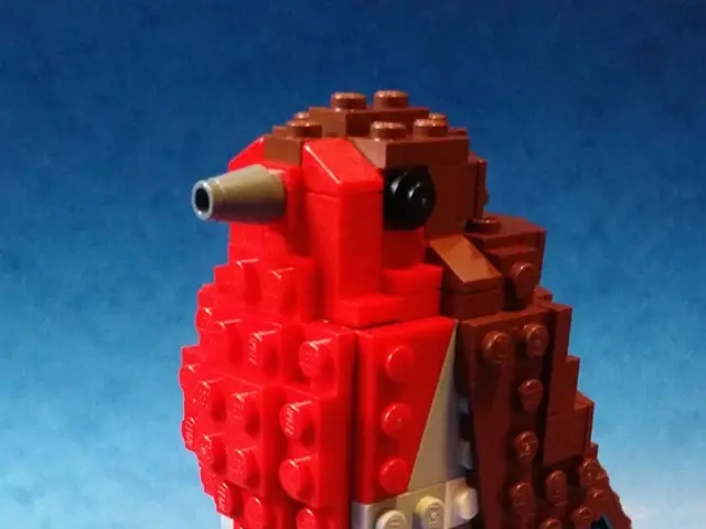 In this picture we can see a toy made of building blocks and this toy is placed on a blue platform.