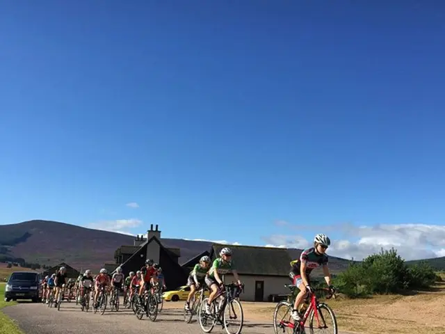 In this picture there are many people who are cycling and the background is the sky.